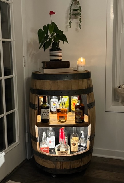 whiskey barrel bar lights on in light room